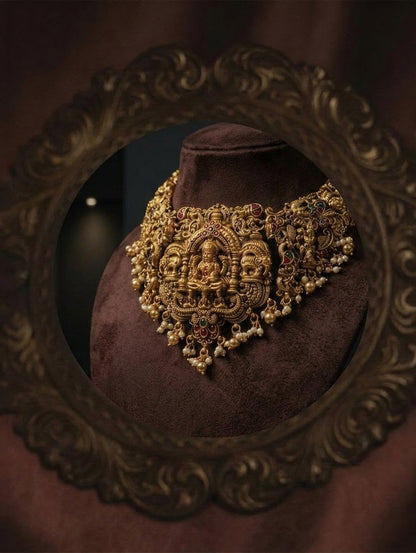 Angled necklace shown in brown bust reflection, framed by an ornate carved-looking border