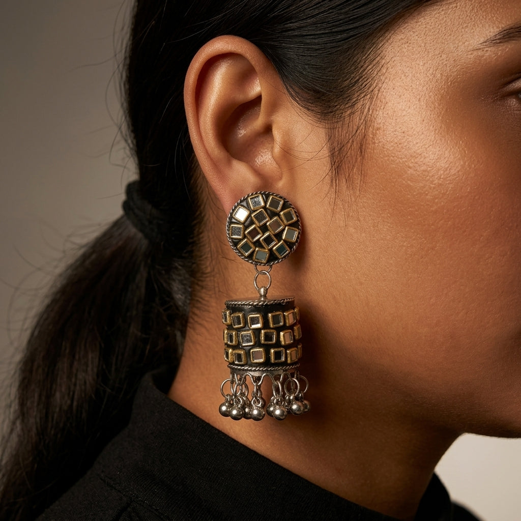 Close-up side view showing a geometric drop earring with dangling bead details