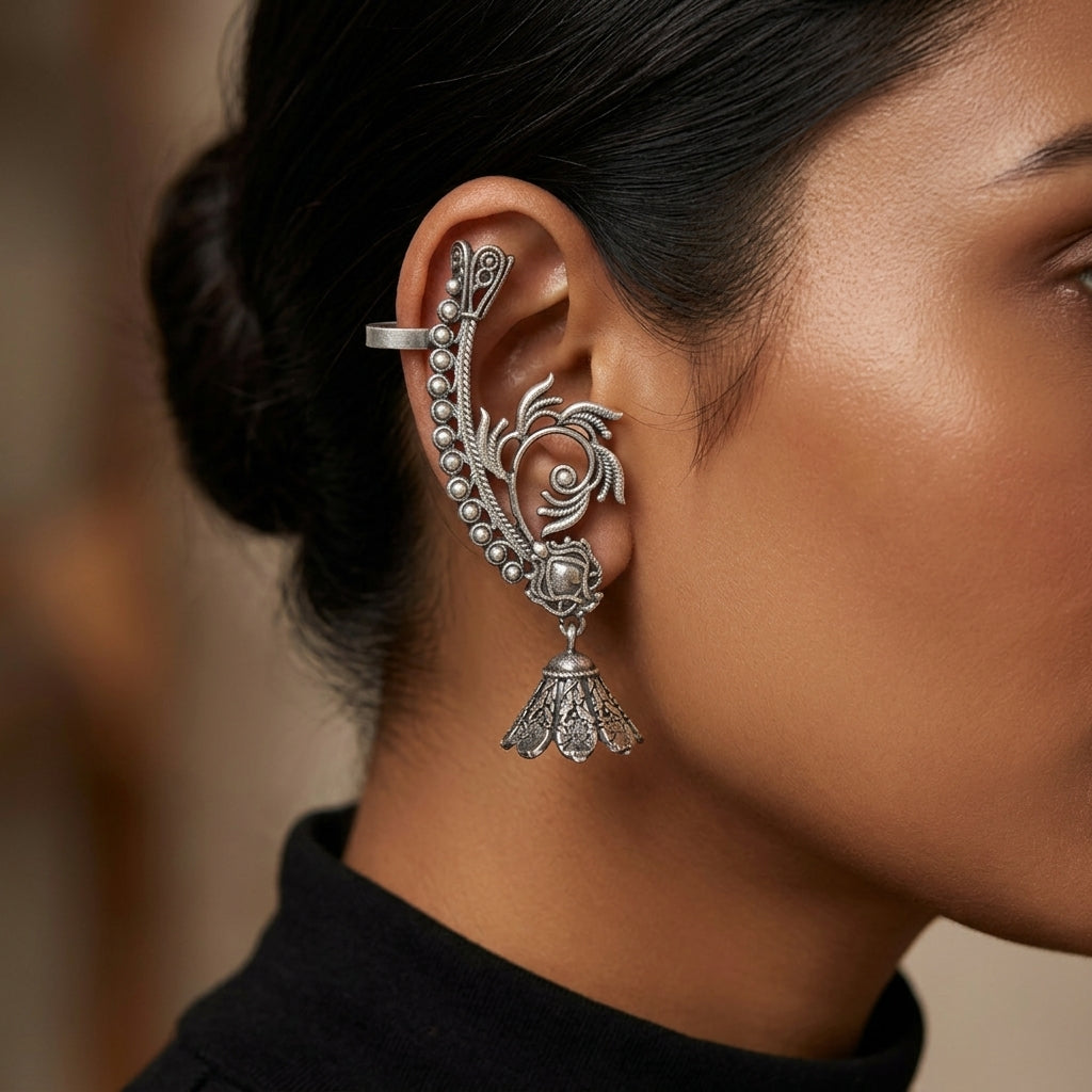 Close-up side view of an ornate ear cuff earring worn along the outer ear