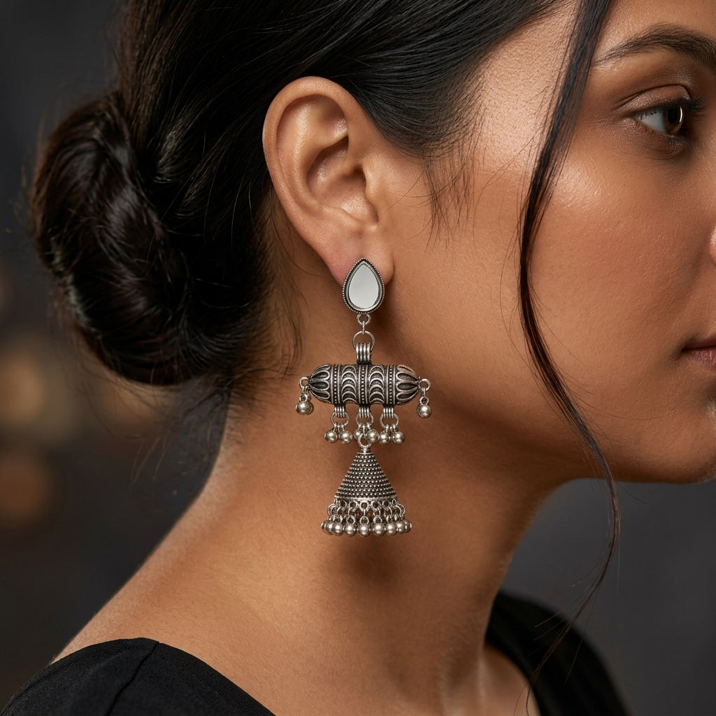 Earring shown worn in profile, with pale teardrop top and layered beaded bell-shaped drop