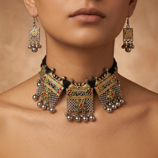 Close-up of dangling floral earrings worn beside an ornate beaded necklace